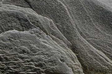 Texture of gray stone with layers and lines. Beautiful gray stone texture for background and pattern. Beautiful stone texture made by wind and sea