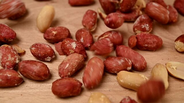 slow motion of roasted salty peanuts falling