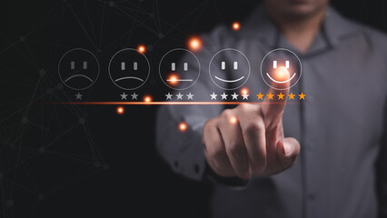 Customer service and Satisfaction concept ,Business people are touching the virtual screen on the happy Smiley face icon to give satisfaction in service. rating very impressed