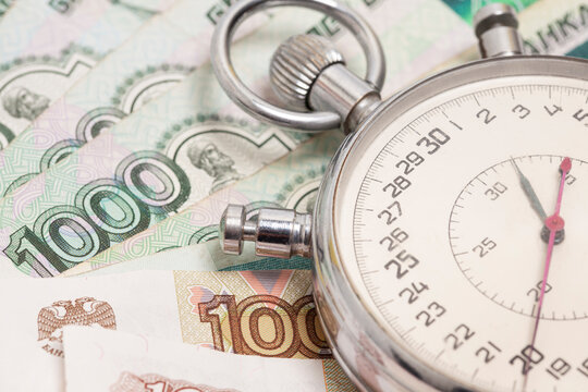 Time is money concept, Stopwatch on Russian ruble banknotes.