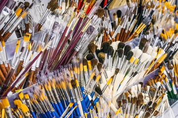 Many brushes Of different sizes and shapes closeup in art store, art background