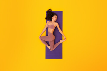 Young Fitness Lady In Sportswear Exercising Lying On Yellow Background