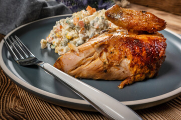 Roast chicken served with russian traditional salad.