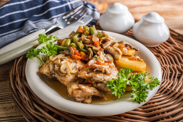 Fillet of chicken legs with stewed vegetables.