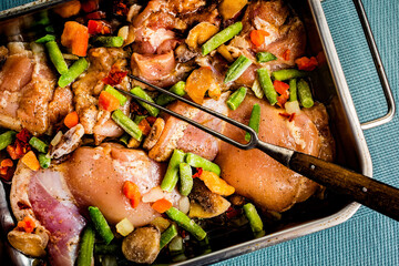 Prepared for baking chicken meat with vegetables.