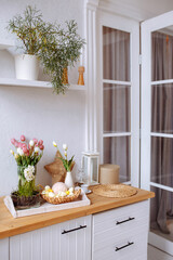 Background image of a minimal kitchen interior in white with fresh flowers on a wooden countertop, copy space.