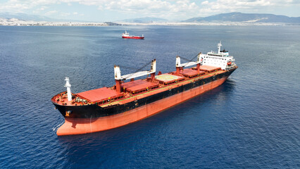 Aerial drone photo of huge bulk carrier tanker anchored in deep blue Aegean sea