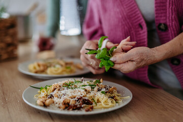 Cooking pasta with basil in the kitchen.