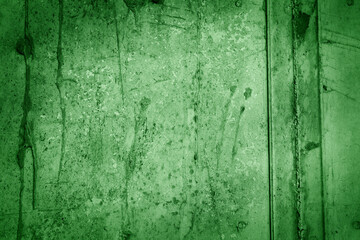 A stone wall painted in green color.