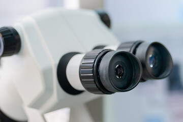 Ocular lens, eyepieces of white optical microscope - close up. Science, biology, optical, laboratory equipment and education concept