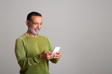 Glad mature european man chatting on smartphone in social networks, isolated