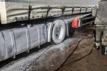Washing a large truck with car shampoo. Background for car service. Truck washing outdoors....
