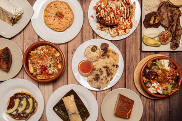 Set of typical dishes of Central American cuisine with tamales, catrachas, roast beef, quesillo