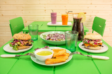 A bright green restaurant table with a set of Peruvian food dishes with cassava