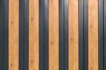 Modern building materials painted metal aluminum panels and plastic panels with wood texture as background.