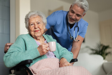 Caregiver doing regular check-up of senior woman in her home.