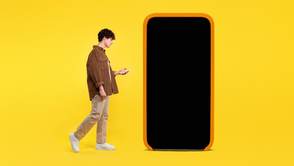 Man Near Giant Cellphone Screen Websurfing On Smartphone, Yellow Background