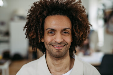 Portrait of young multiracial man in office.