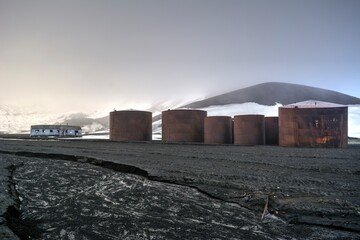 Photo of a group of tanks in a barren field in Antarctica
