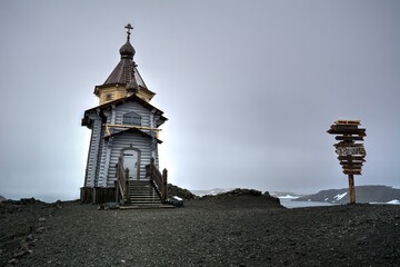 Photo of a picturesque church with a steeple overlooking a snowy hill in Antarctica © turventur