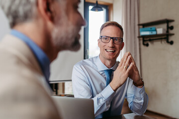 Colleagues talking about work in an office.