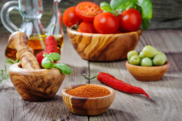 ripe tomatoes and red onion chili peppers on the wooden desk