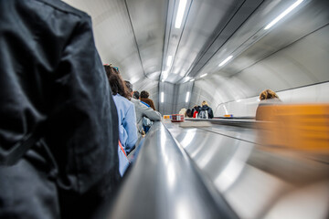 People on escalator in underground station. London, UK, Europe