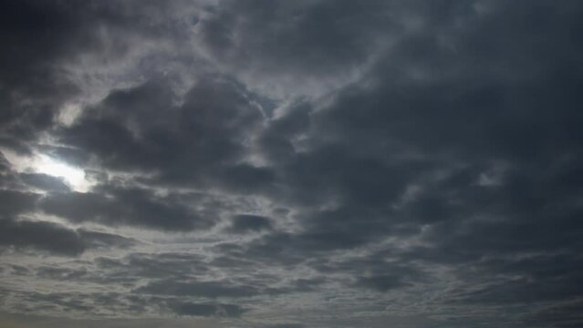 Stratocumulus clouds are patchy gray or white clouds that often have a dark honeycomb-like appearance. beautiful dark dramatic sky with stormy clouds before the rain or snow