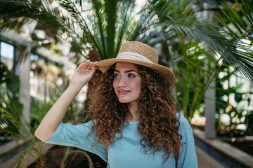 Portrait of young woman in botanical garden.