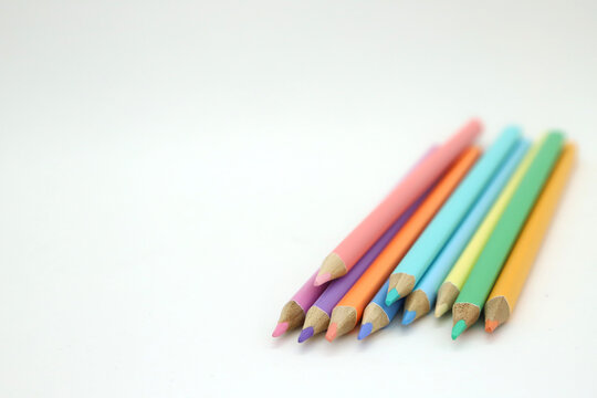 Pencils for painting and drawing in pastel colors. School supplies on white background isolated and with empty space for texts. Accessory for schools, students and illustrators.