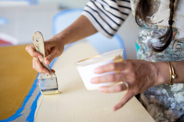 An artist paints in her studio