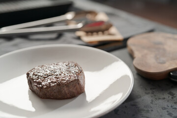 Whole beef steak on white plate