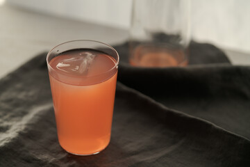 Guava drink in tumbler glass on linen cloth