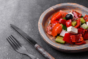 Delicious fresh juicy greek salad with feta cheese, olives, peppers and tomatoes