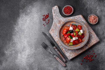 Delicious fresh juicy greek salad with feta cheese, olives, peppers and tomatoes