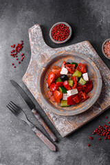 Delicious fresh juicy greek salad with feta cheese, olives, peppers and tomatoes