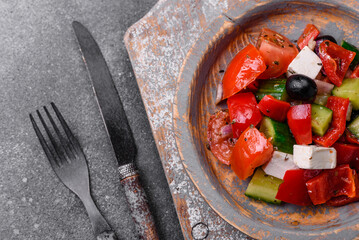 Delicious fresh juicy greek salad with feta cheese, olives, peppers and tomatoes