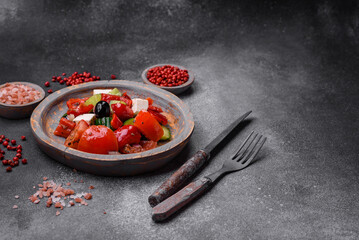 Delicious fresh juicy greek salad with feta cheese, olives, peppers and tomatoes