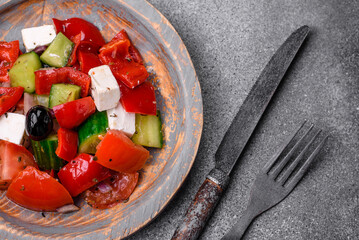 Delicious fresh juicy greek salad with feta cheese, olives, peppers and tomatoes
