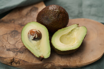 Ripe avocados on olive wood board