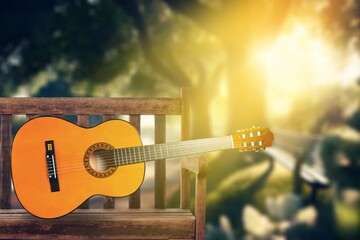 Beautiful musical classical guitar on a wooden bench