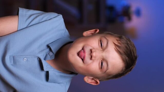 vertical video boy teasing and showing tongue