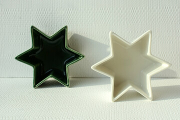 ceramic souvenir bowls in the shape of a star on a light background