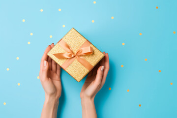 two joined hands holding a golden gift box with glittering ribbons, gratitude and affection, human connection through christmas celebration concept,Generative AI