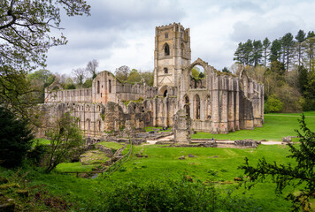 Detail of the ruins of Fountains Abbey in Yorkshire, United Kingdom in the spring as leaves start...