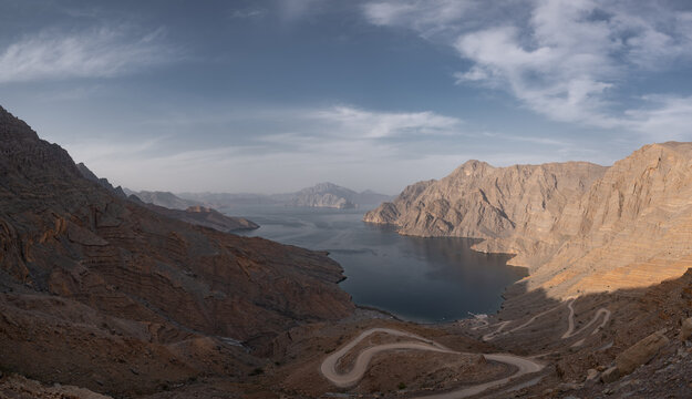 A view of Khor Najd in Musandam Oman, with a winding road down to the beach