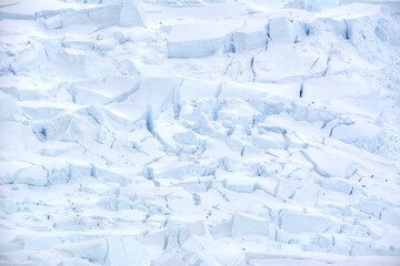 Photo of a breathtaking view of a vast expanse of icebergs floating in the crystal-clear waters of Antarctica