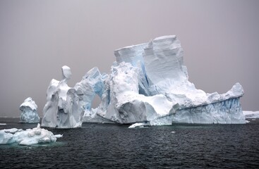 Photo of a majestic iceberg floating in the vast ocean, showcasing the beauty and grandeur of Antarctica
