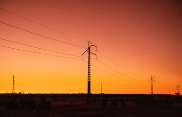 Power lines at dawn outside of Alice Springs, Northern Territory, Australia - obrazy, fototapety, plakaty