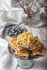 Streusel pie with currant and rose petal filling on a light background.